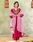 A woman wearing Pink Colored Silk Kurta Set with Organza Dupatta.