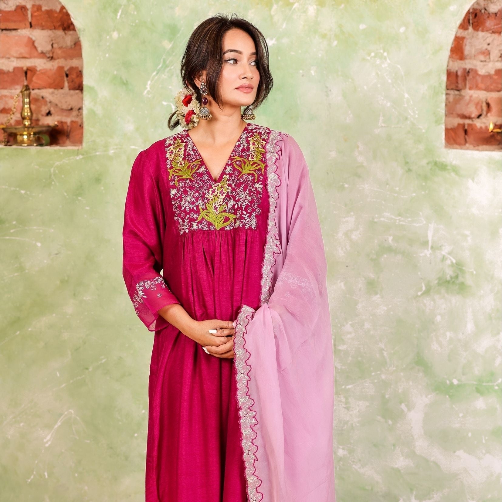 A woman wearing Pink Colored Silk Kurta Set with Organza Dupatta.