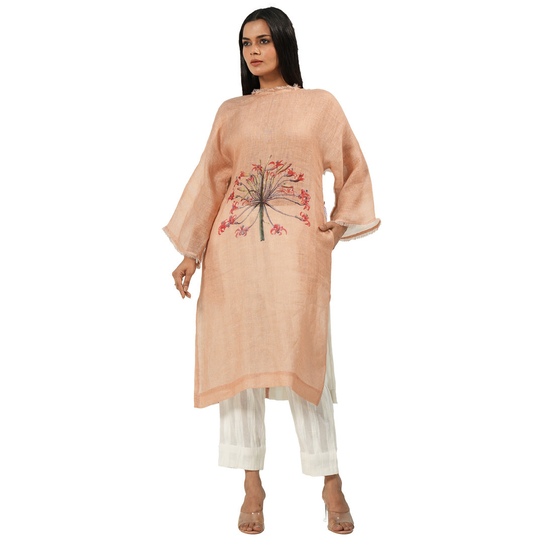 A women wearing stylish full sleeves pink kurta set with white pants.