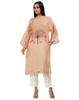 A women wearing stylish full sleeves pink kurta set with white pants.