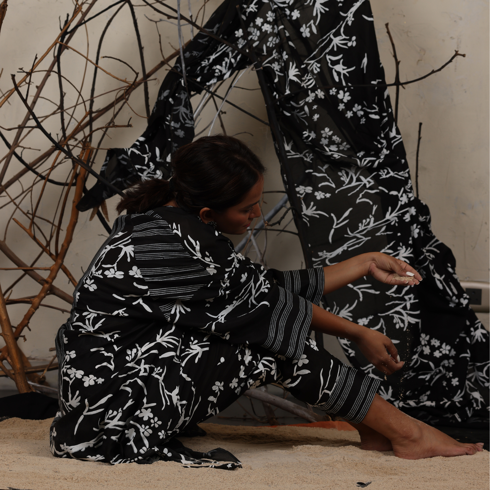 A woman sitting on the floor wearing Black and White Silk Co-Ord Set.