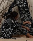 A woman sitting on the floor wearing Black and White Silk Co-Ord Set.