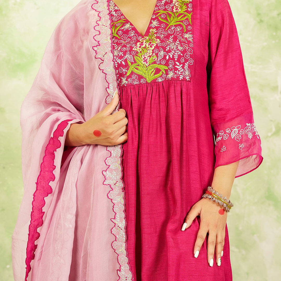 A woman wearing Pink Colored Silk Kurta Set with Organza Dupatta.