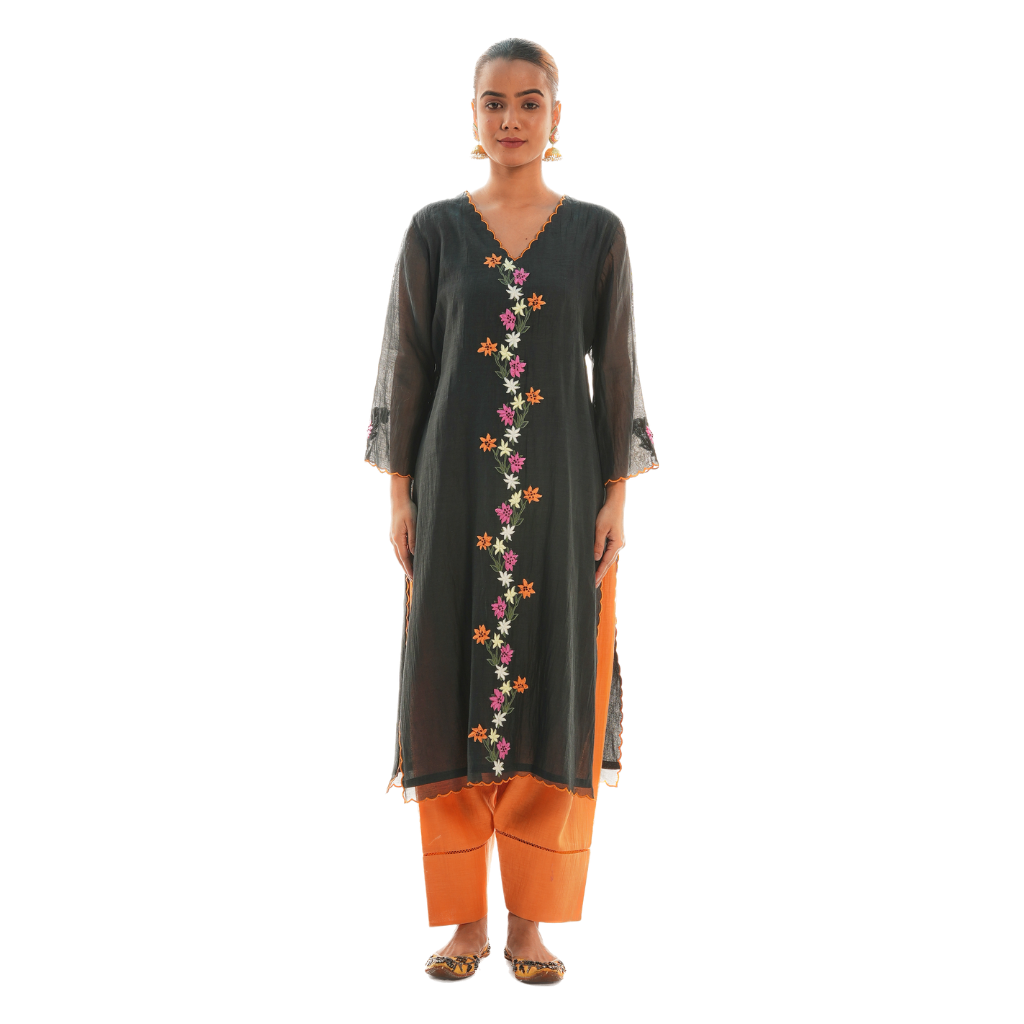 A women wearing black colored kurta set with orange colored pants.