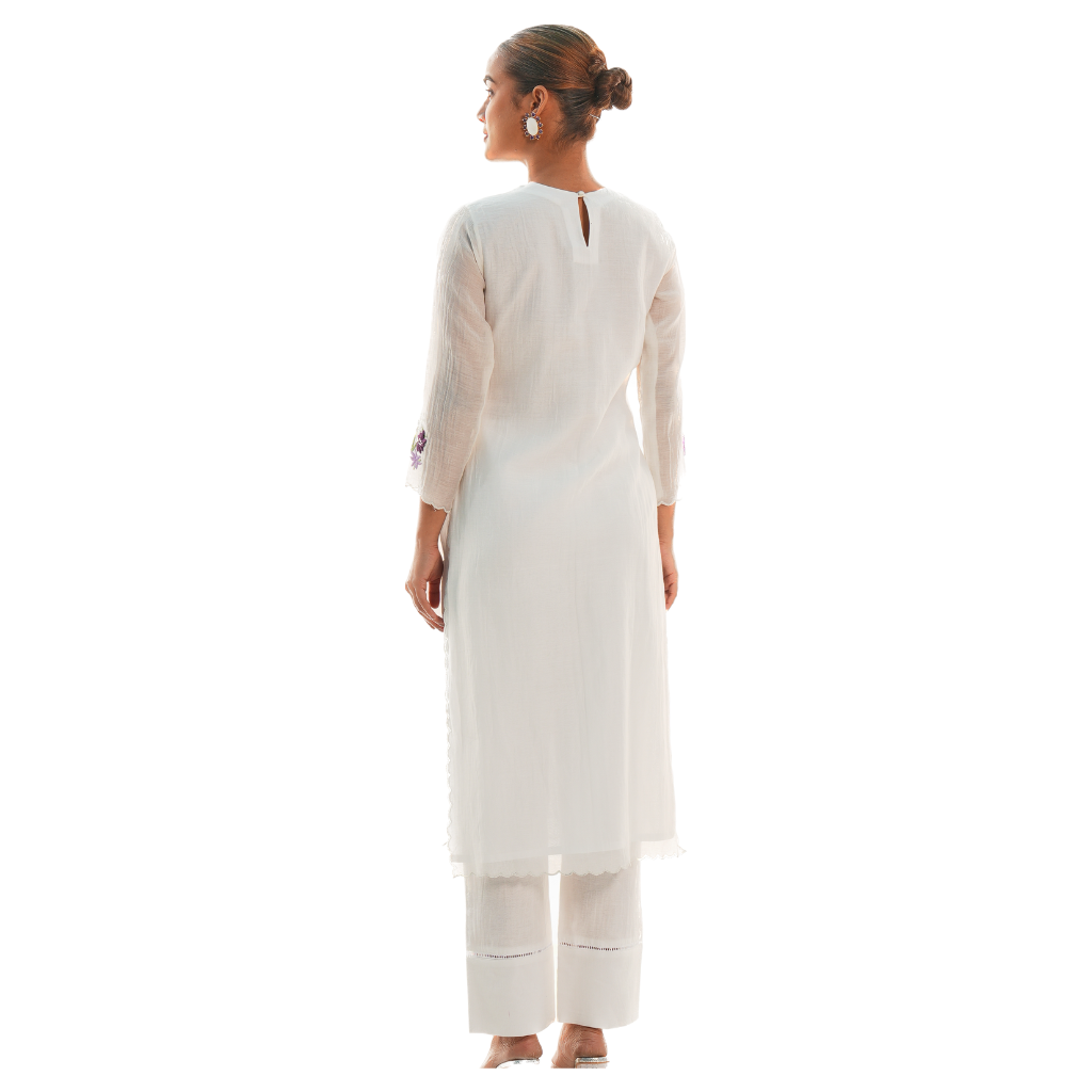 A women wearing designer white kurta set.