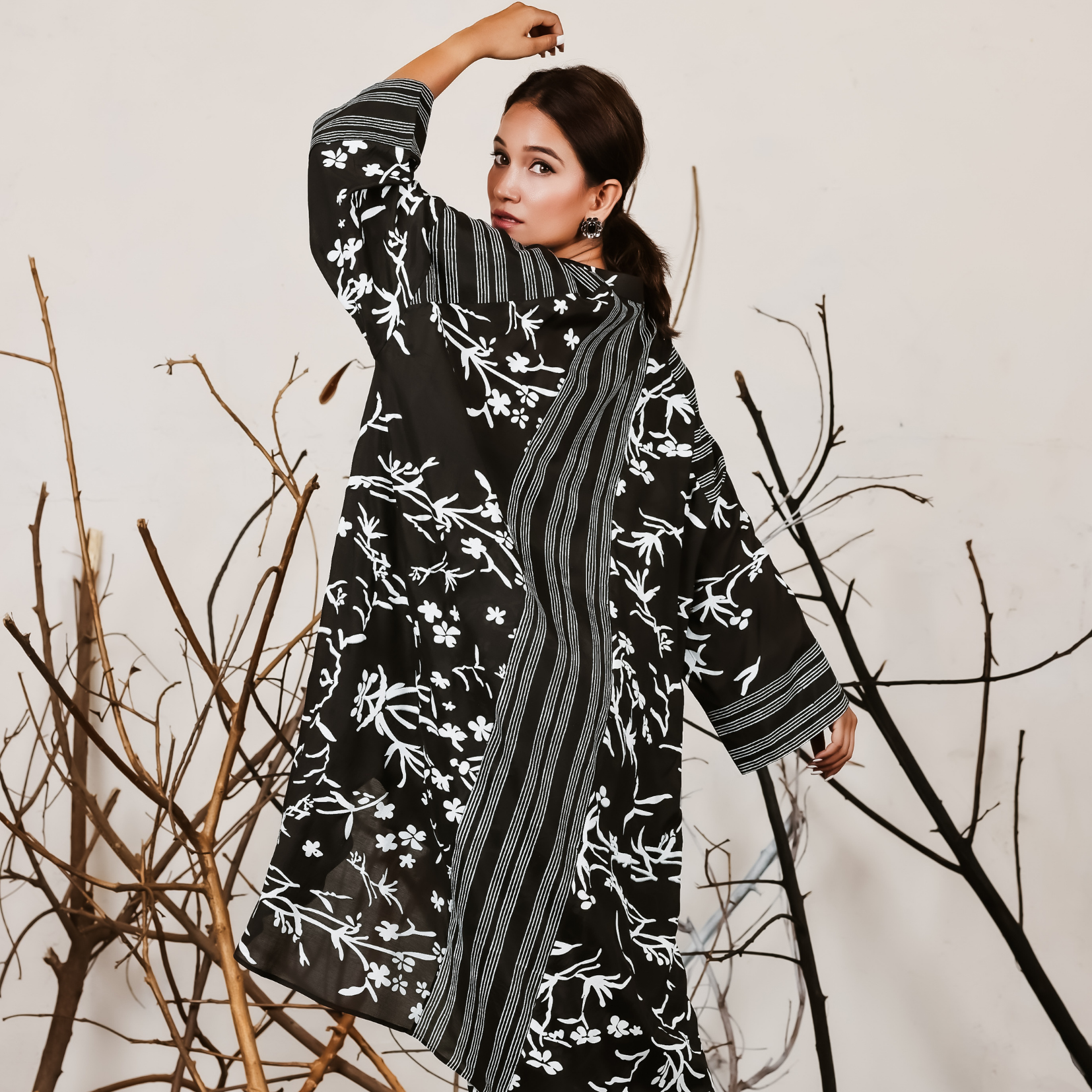 A woman standing towards the wall wearing Black and White Silk Co-Ord Set.