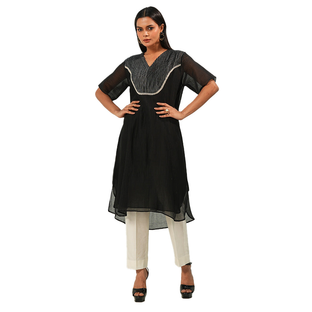 A women wearing Black Kurta Set with White Pants.