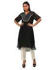 A women wearing Black Kurta Set with White Pants.