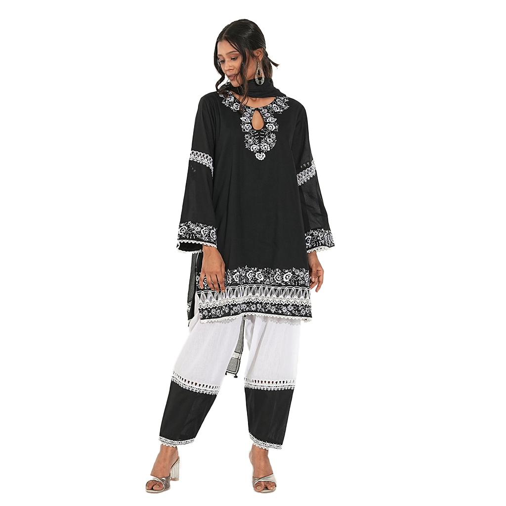 A women wearing black and white suit set with pants and dupatta.