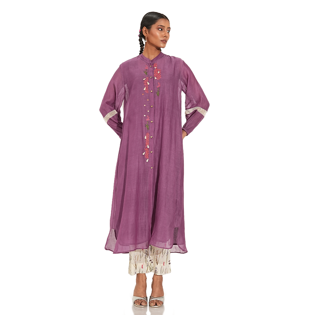 A woman wearing Purple Colored Kurta Set with White Printed Pants.