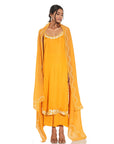 A women wearing stylish whole orange kurta set with palazzo and dupatta.