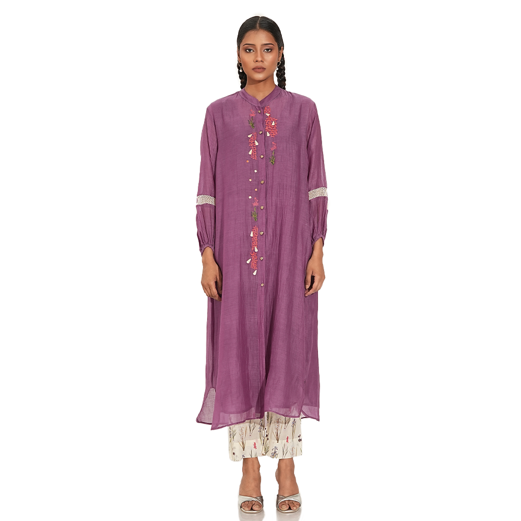 A woman wearing Purple Colored Kurta Set with White Printed Pants.