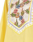 A women wearing yellow colored kurta set.