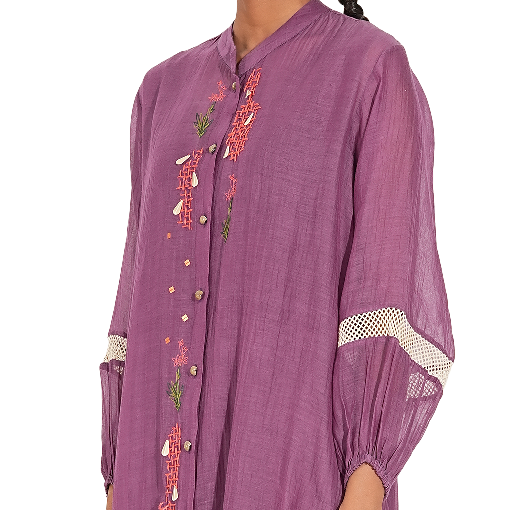 A woman wearing Purple Colored Kurta Set with White Printed Pants.