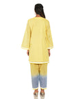 A women wearing yellow colored kurta set with yellow and blue pants.