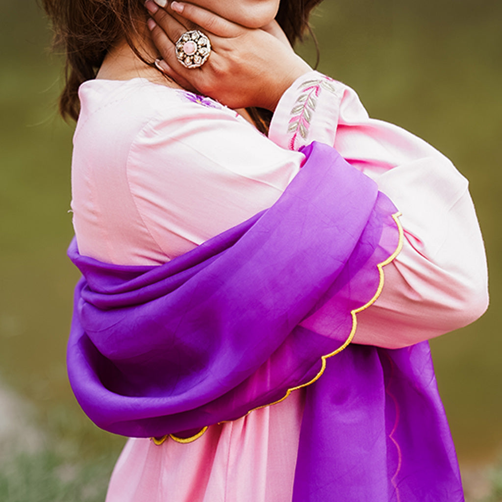 A woman wearing Purple and Blue Kurta Set with Yellow Colored Pants and Dupatta.