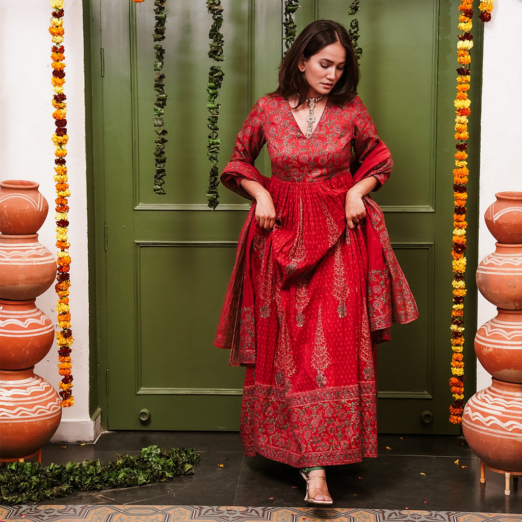 A women wearing Red Anarkali Suit Set with Dupatta.