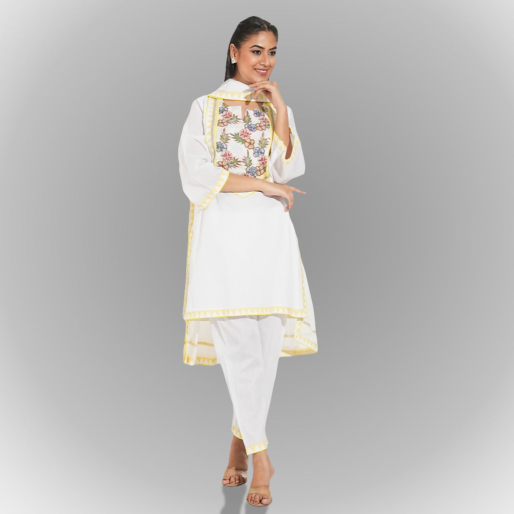 A women wearing white colored kurta set with dupatta with flowery design in it.