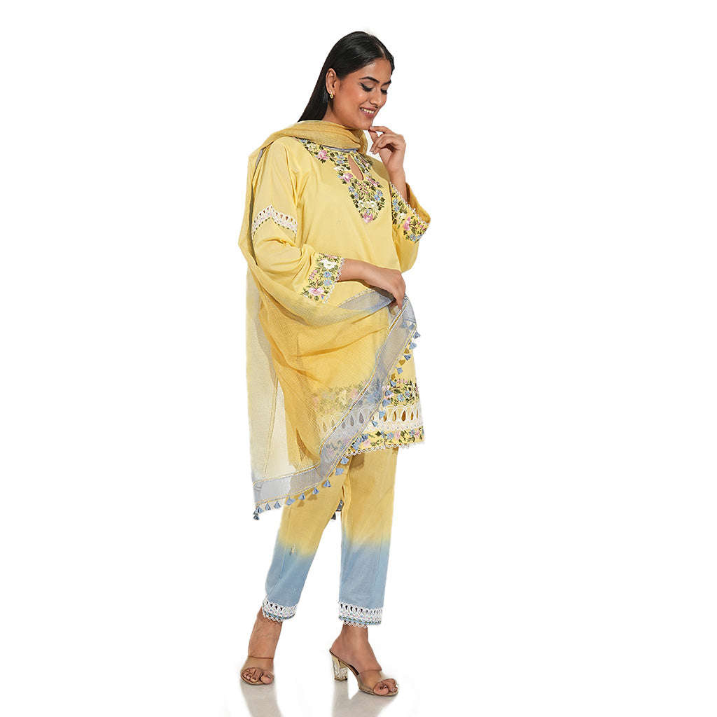 A women wearing yellow colored suit set with pants and dupatta.