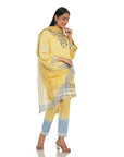 A women wearing yellow colored suit set with pants and dupatta.