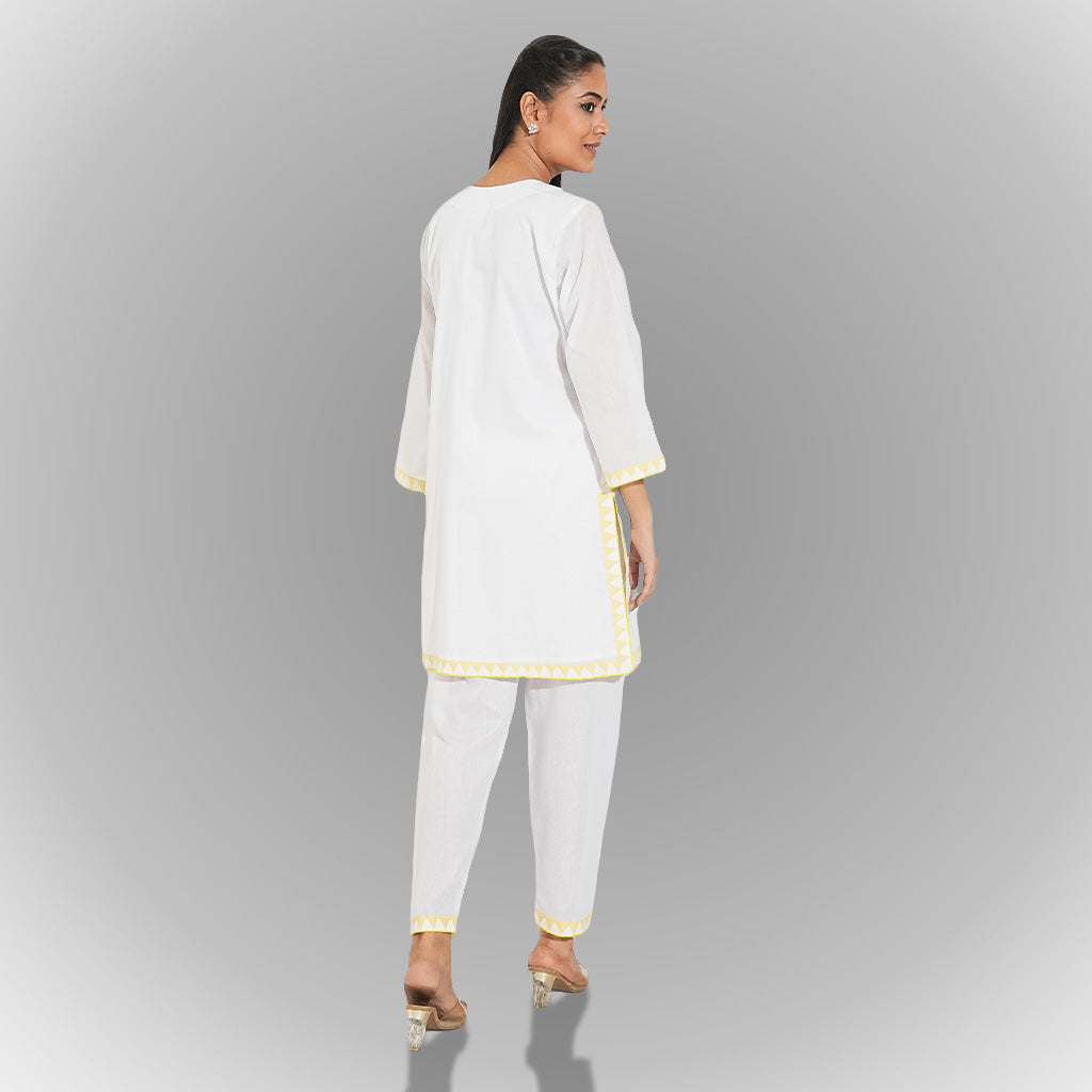 A women wearing white colored kurta set.