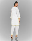 A women wearing white colored kurta set.