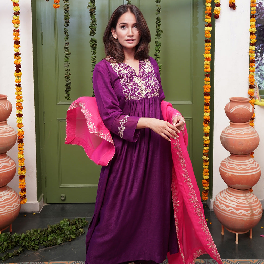 A woman wearing Pink Colored Silk Kurta Set with Organza Dupatta.