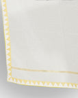 A dupatta fabric with yellow colored border in it.