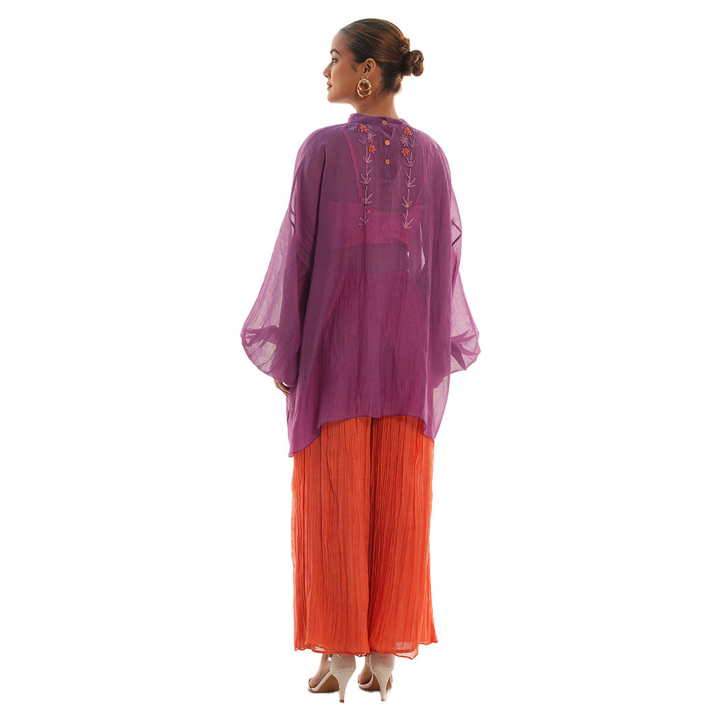 A woman wearing Purple and Orange colored co-ord set.